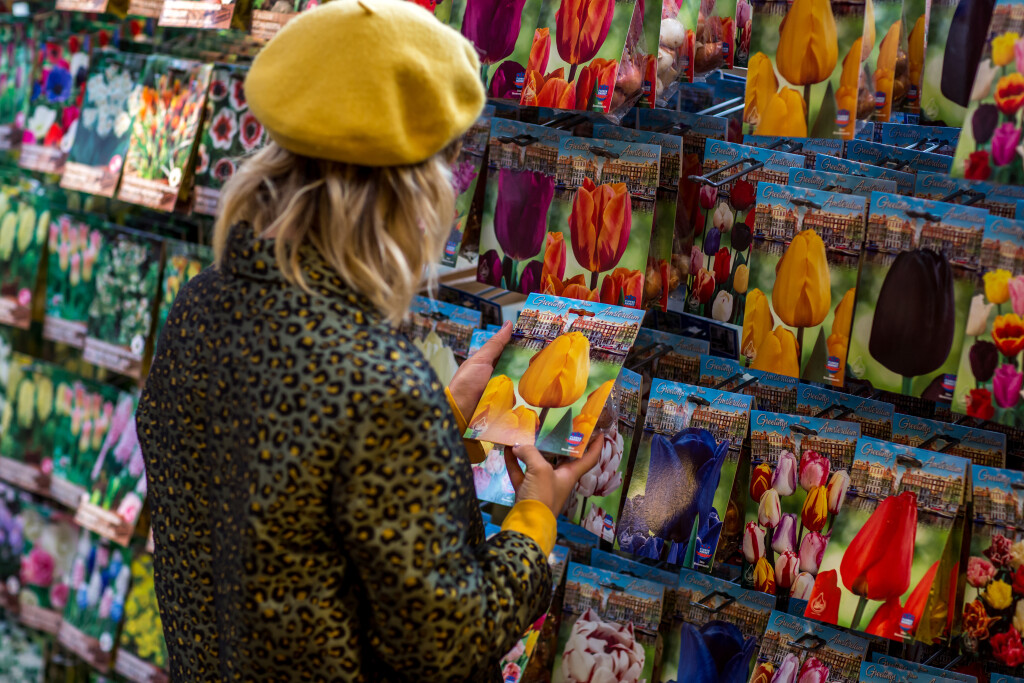 AMSTERDAM, NETHERLANDS- September 18, 2019: Young woman shopping for flower seeds in famous flower market